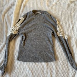 Grey crop sweater with open lace detailing on sleeves